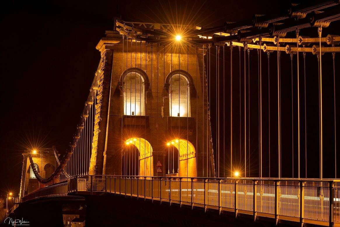 Menai suspension bridge illuminated at night in North Wales