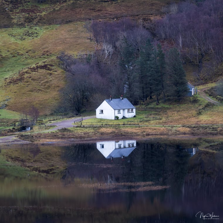 Highland Haven, A house amongst reflections is a fine art print taken in the Scottish Highlands